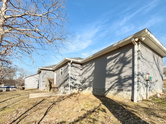 view of side of home with a lawn