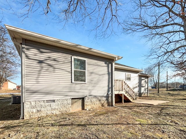 view of side of home featuring cooling unit