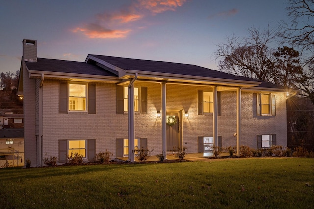 split foyer home featuring a yard