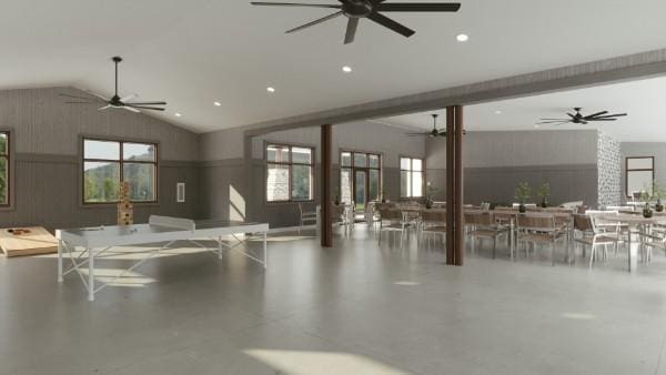 interior space with ceiling fan and wooden walls