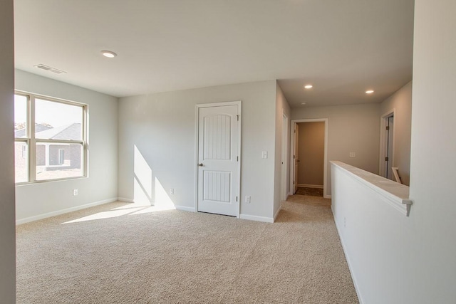 spare room with light carpet