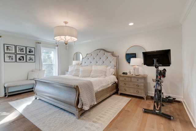 bedroom with ornamental molding and light wood-type flooring