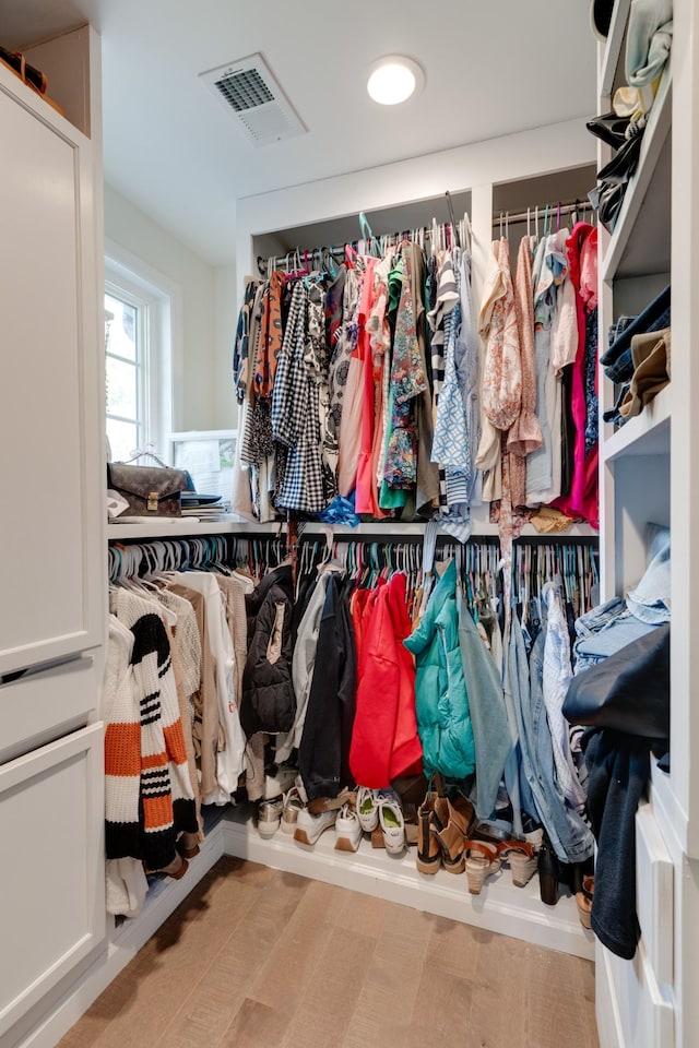 spacious closet featuring light wood-type flooring