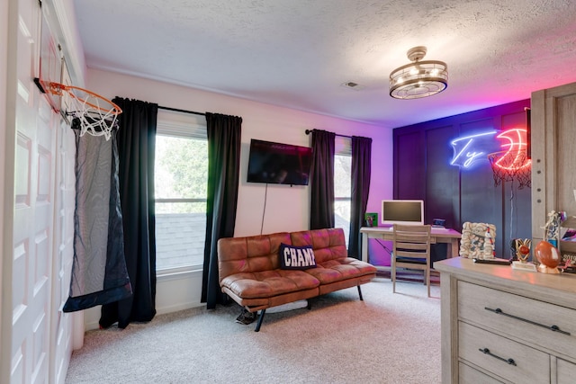 living area with a textured ceiling and light colored carpet