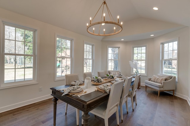 dining space with an inviting chandelier, a wealth of natural light, vaulted ceiling, and dark wood-type flooring