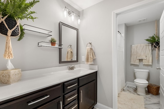 bathroom featuring toilet and vanity