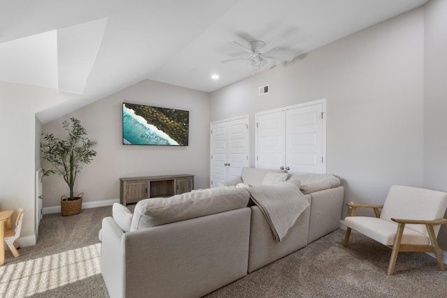 living room featuring ceiling fan, vaulted ceiling, and light colored carpet