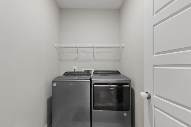 clothes washing area with separate washer and dryer