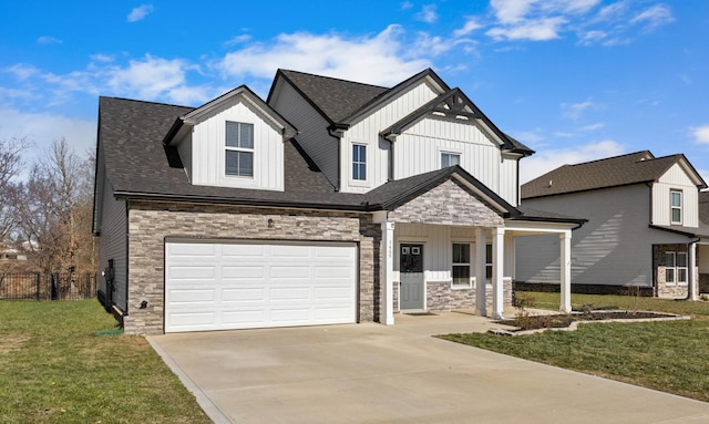 view of front of property featuring a front yard, a garage, and covered porch