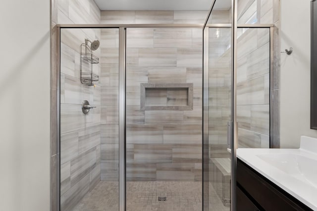 bathroom with walk in shower and vanity