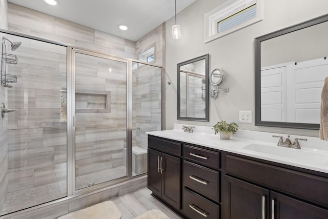 bathroom featuring walk in shower and vanity