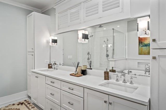 bathroom with vanity, ornamental molding, and separate shower and tub