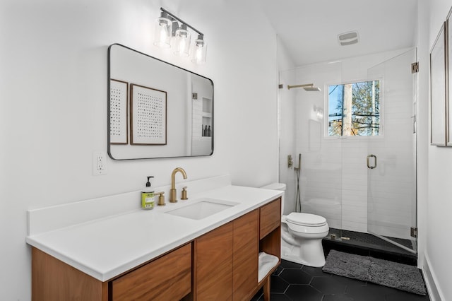 bathroom featuring toilet, an enclosed shower, vanity, and tile patterned floors