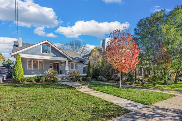 view of front of house featuring covered porch and a front lawn