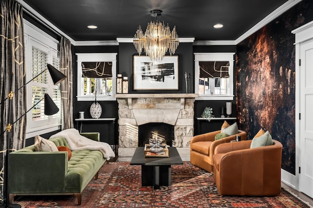 living area featuring ornamental molding, a stone fireplace, and a chandelier