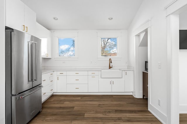 kitchen featuring sink, white cabinets, and high end fridge