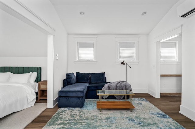 bedroom featuring lofted ceiling, dark wood-type flooring, and a wall mounted AC