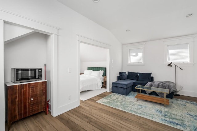 living room with lofted ceiling and light wood-type flooring