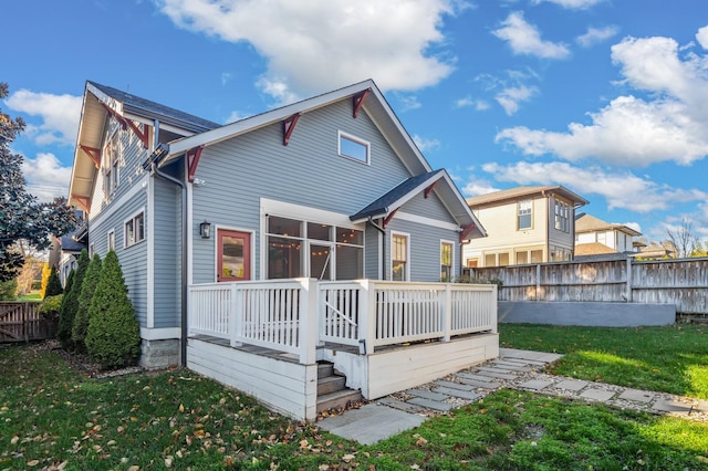 back of house featuring a yard and a wooden deck