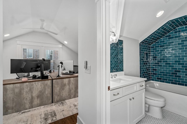 full bathroom featuring toilet, lofted ceiling, ceiling fan, tiled shower / bath, and vanity