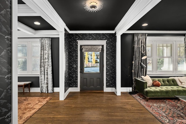 entrance foyer with ornamental molding and dark hardwood / wood-style floors