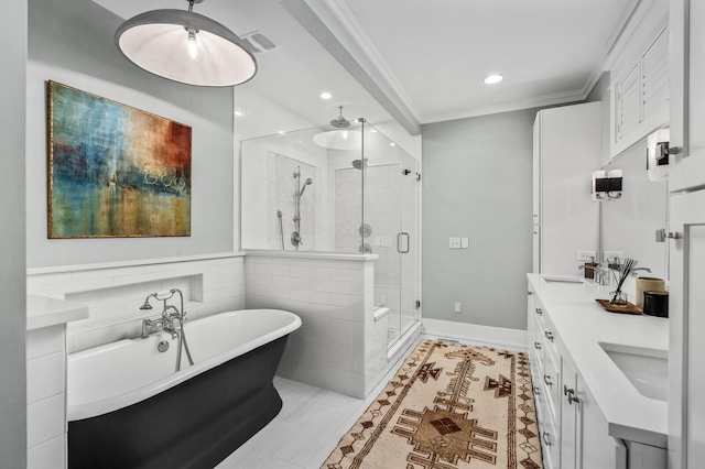 bathroom with vanity, tile patterned flooring, crown molding, and plus walk in shower