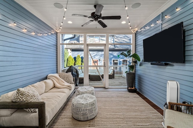 sunroom / solarium featuring ceiling fan and wooden ceiling