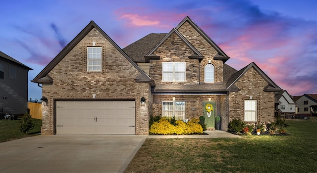 front of property featuring a lawn and a garage