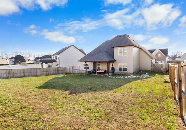 back of house featuring a patio and a yard