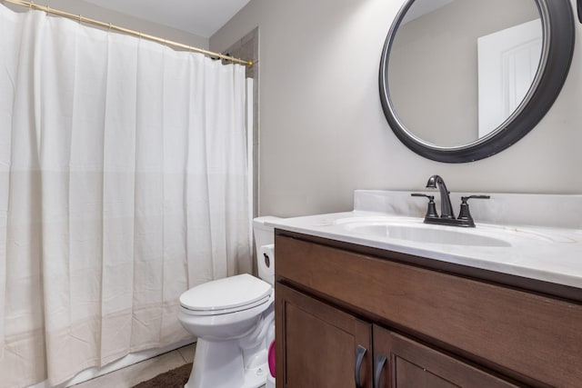 bathroom featuring vanity, tile patterned floors, and toilet