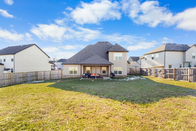 back of house with a patio and a yard