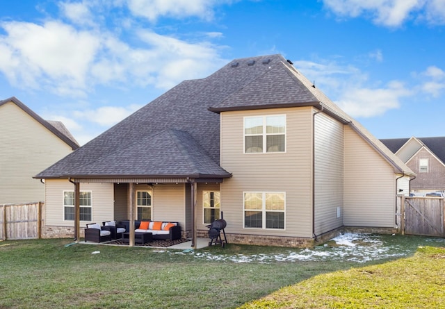 rear view of property featuring a yard, a patio area, and outdoor lounge area