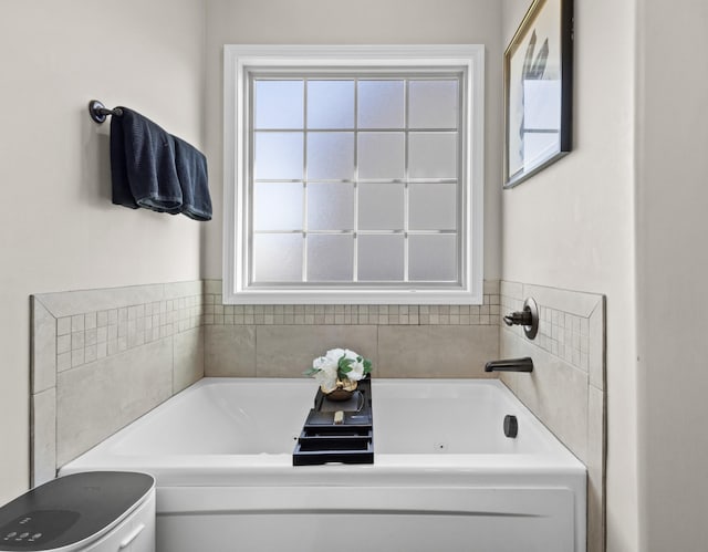 bathroom with a bathtub and plenty of natural light