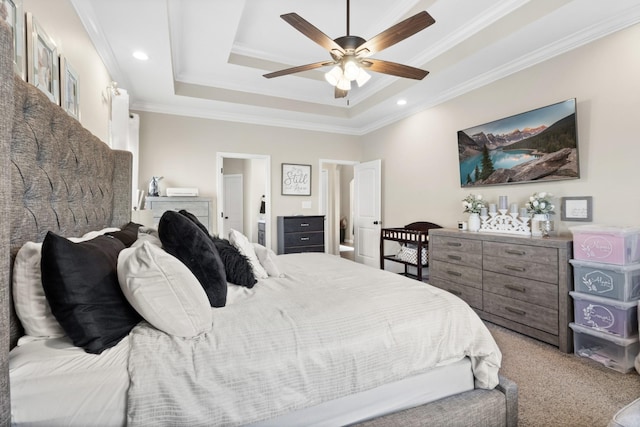 bedroom featuring a raised ceiling, ceiling fan, carpet, and crown molding