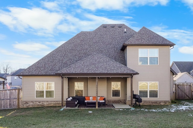 rear view of house with a patio area, outdoor lounge area, and a yard