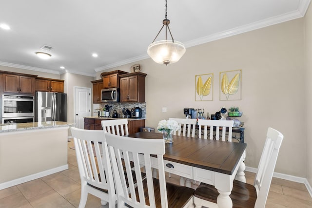 dining room featuring ornamental molding and light tile patterned floors