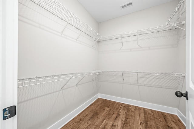 spacious closet with wood finished floors and visible vents