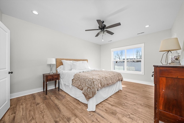 bedroom with recessed lighting, light wood-type flooring, and baseboards