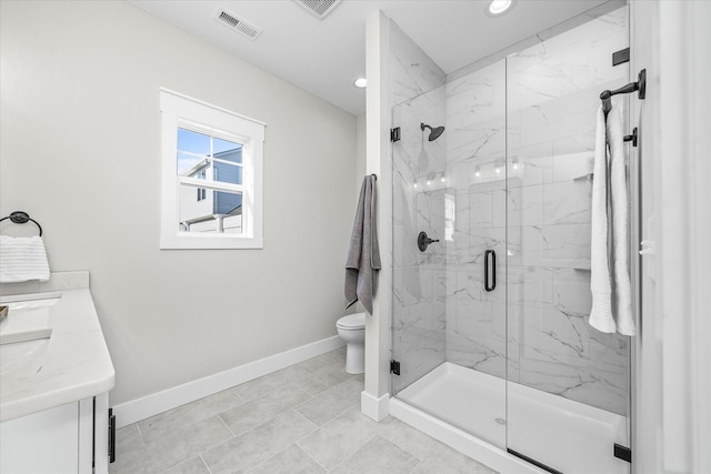 bathroom featuring visible vents, toilet, a marble finish shower, baseboards, and vanity