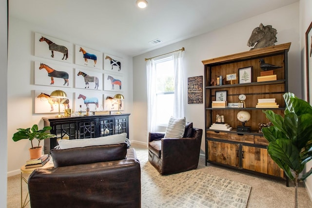 living area featuring light carpet