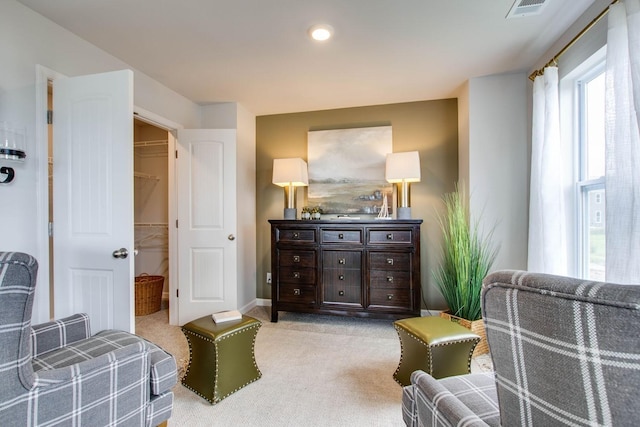 sitting room featuring light carpet