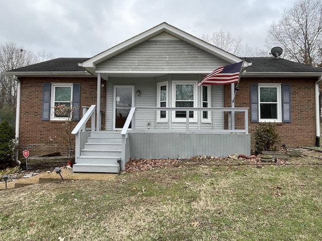 view of front facade with a porch and a front lawn