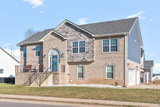 view of front of property with a garage and a front lawn