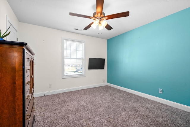 unfurnished bedroom featuring ceiling fan and carpet flooring