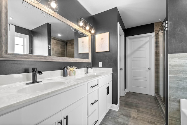 bathroom with an enclosed shower and vanity