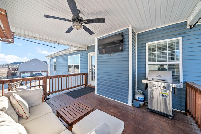 wooden deck featuring ceiling fan, a grill, and an outdoor living space