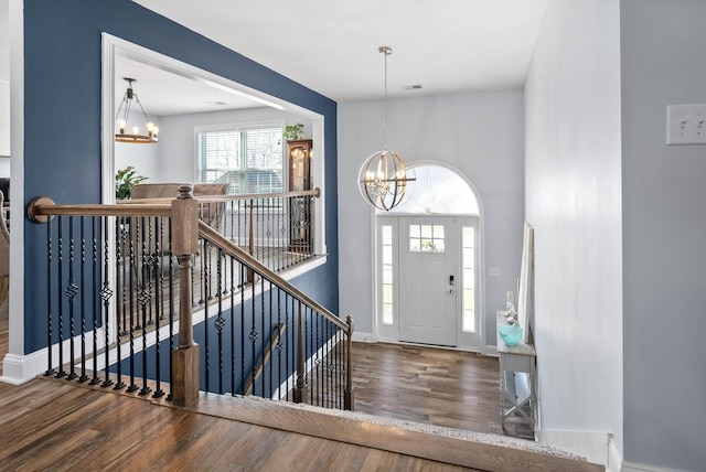 foyer entrance featuring a notable chandelier and hardwood / wood-style flooring