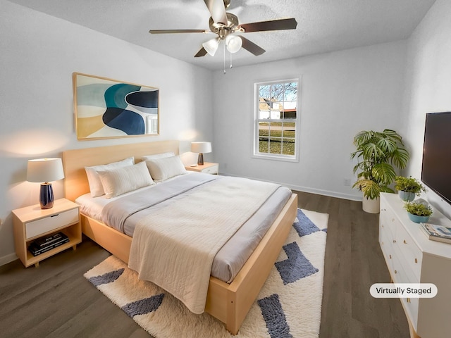 bedroom with dark wood-type flooring, a textured ceiling, and ceiling fan