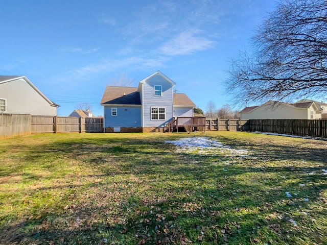 rear view of house featuring a deck and a lawn