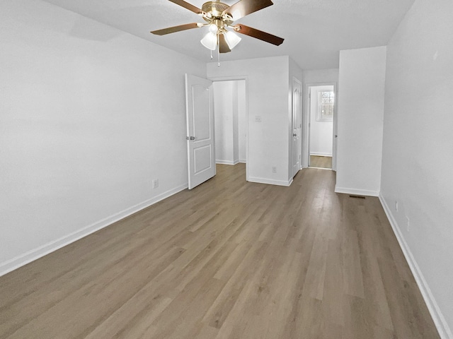 unfurnished bedroom with ceiling fan and light hardwood / wood-style flooring